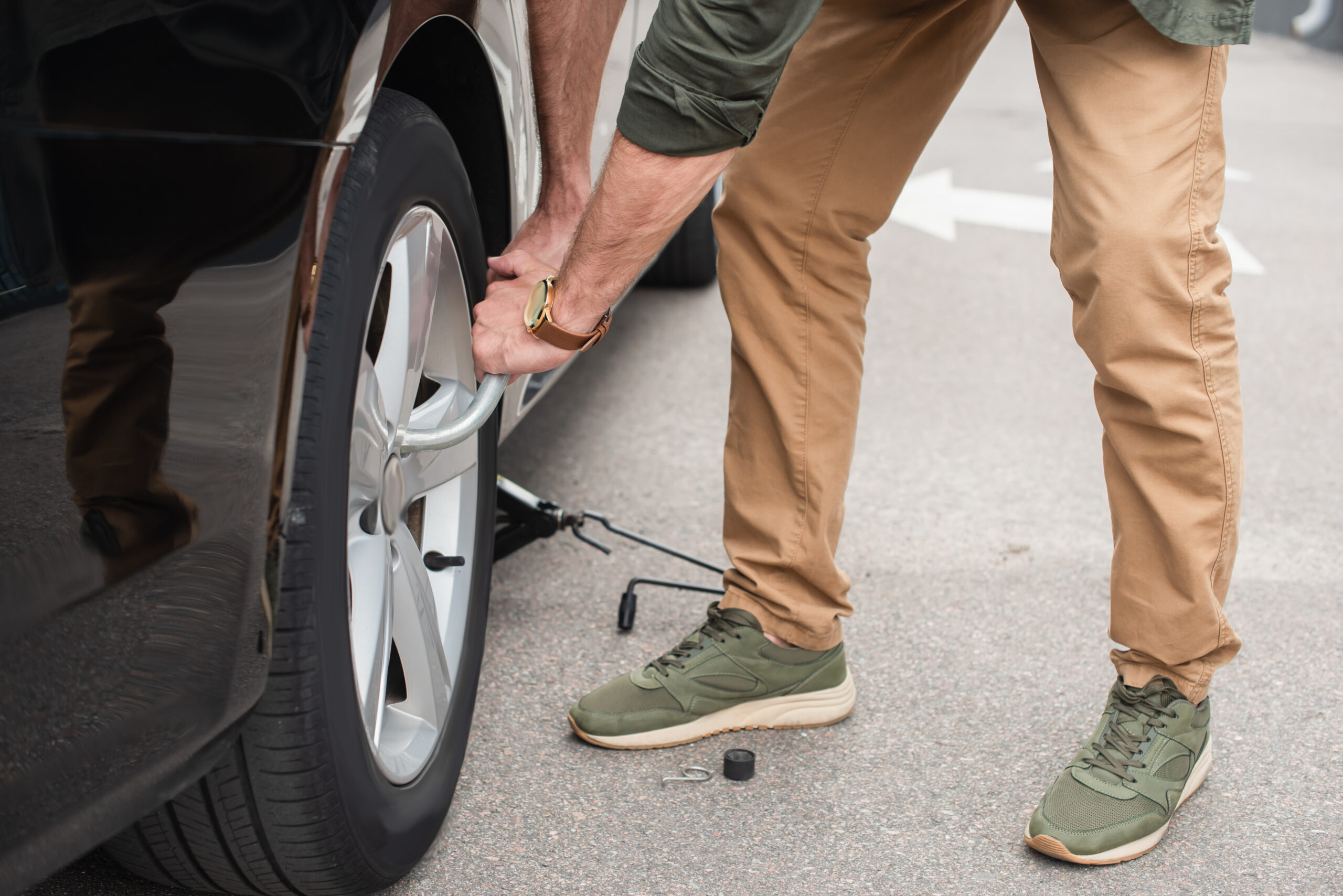 cropped view of man using wheel wrench on car outd 2024 11 07 16 38 11 utc scaled